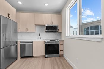 A kitchen with wooden cabinets and stainless steel appliances.
